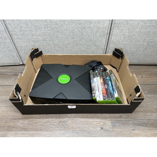 833 - A Microsoft Xbox with games and accessories