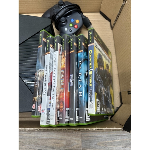 833 - A Microsoft Xbox with games and accessories