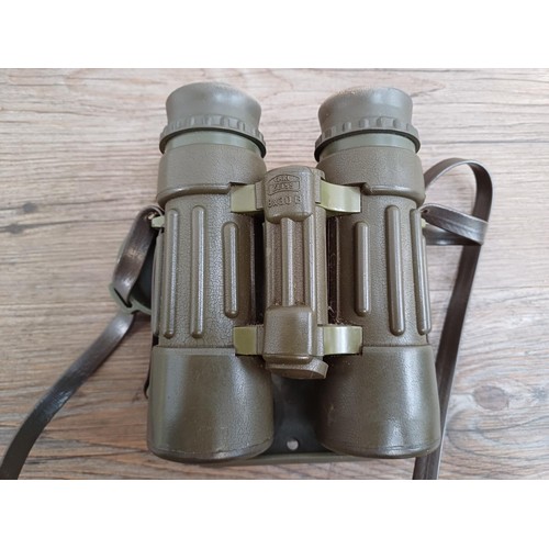 570 - A pair of Carl Zeiss Dialyt 8 x 30B safari green, rubber armoured binoculars with attached covers