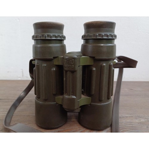 570 - A pair of Carl Zeiss Dialyt 8 x 30B safari green, rubber armoured binoculars with attached covers