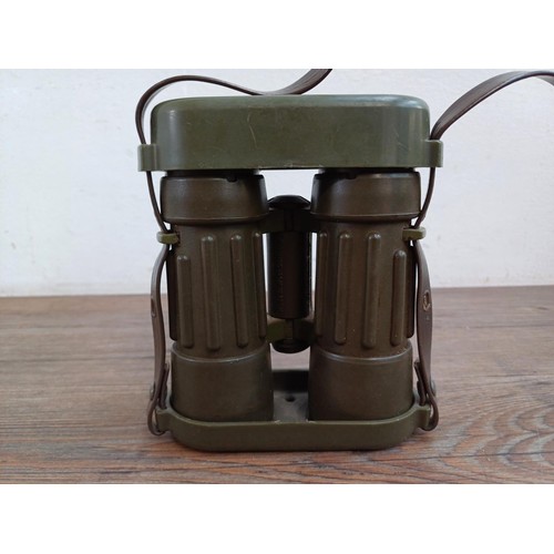 570 - A pair of Carl Zeiss Dialyt 8 x 30B safari green, rubber armoured binoculars with attached covers