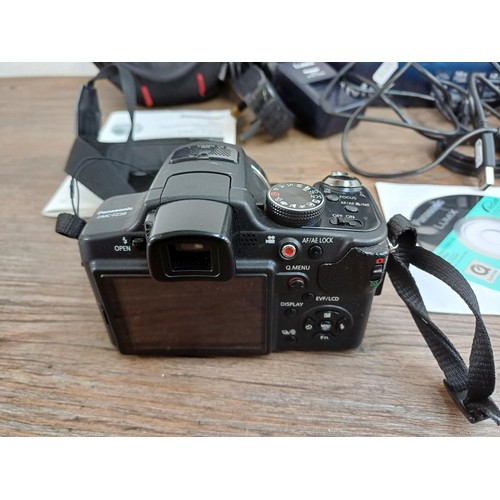 581 - Two cameras, one boxed and cased Panasonic DMC-FZ38 12.1mp compact digital with charger, spare batte... 