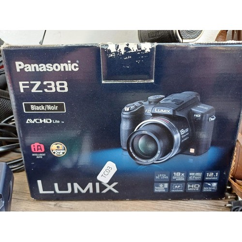 581 - Two cameras, one boxed and cased Panasonic DMC-FZ38 12.1mp compact digital with charger, spare batte... 