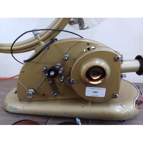 584 - A mid 20th century Pathéscope Gem 9.5mm cine projector with three film reels and two empty reels tog... 