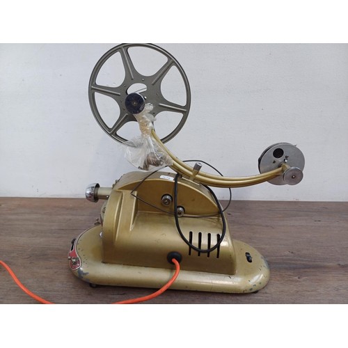 584 - A mid 20th century Pathéscope Gem 9.5mm cine projector with three film reels and two empty reels tog... 