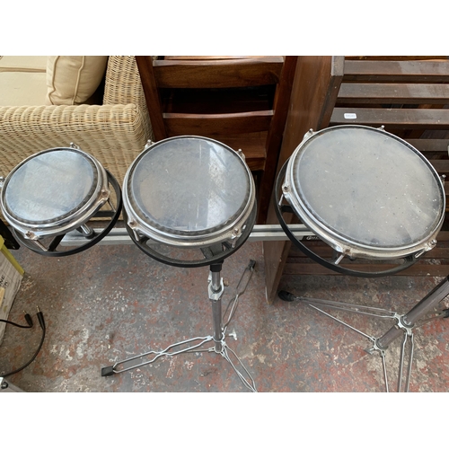 714 - Two percussion items on double braced tripod stands, one pair of Kent tuneable bongos and one set of... 