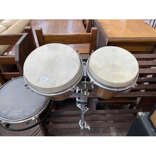 714 - Two percussion items on double braced tripod stands, one pair of Kent tuneable bongos and one set of... 