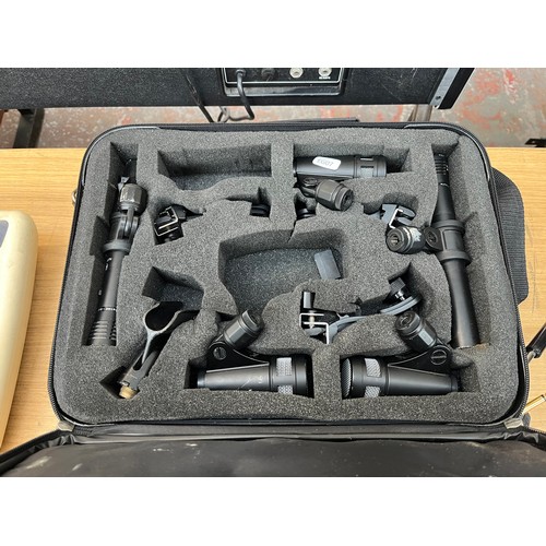 677 - A collection of microphones and related items to include cased NJD drum microphones, cased AKG, Shur... 