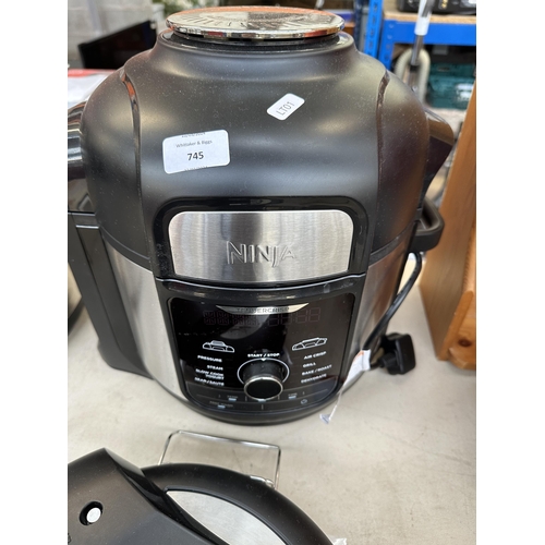 745 - A Ninja OP500UK air fryer and pressure cooker with cookbook and instruction manual