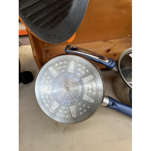 746 - A Le Creuset pan rack with two Le Creuset pans and two Tefal lidded saucepans