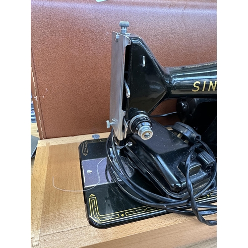 751 - A cased Singer 99K electric sewing machine with foot pedal