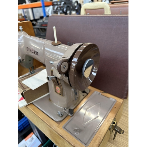 752 - A cased Singer 185K electric sewing machine with boxed attachments and instruction manual