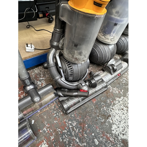 763 - Three Dyson upright bagless vacuum cleaners to include DC41, DC25 etc.