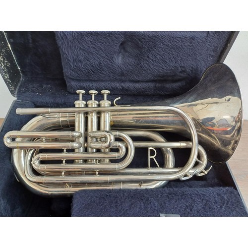 664 - A cased marching Baritone horn with two 6.5 ALL-L mouthpieces