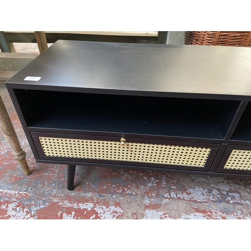 71 - A Vonhaus Whitworth black laminate and cane two drawer TV stand - approx. 51cm high x 120cm wide x 4... 