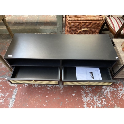 71 - A Vonhaus Whitworth black laminate and cane two drawer TV stand - approx. 51cm high x 120cm wide x 4... 