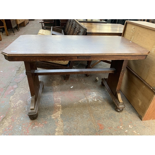 78 - An Art Deco carved oak octagonal drop leaf dining table and two chairs - approx. 74cm high x 106cm w... 