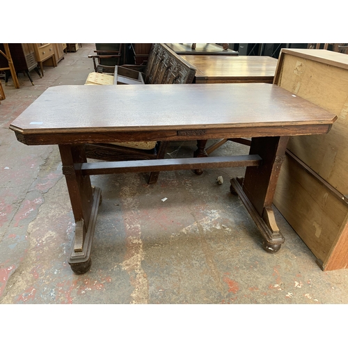 78 - An Art Deco carved oak octagonal drop leaf dining table and two chairs - approx. 74cm high x 106cm w... 