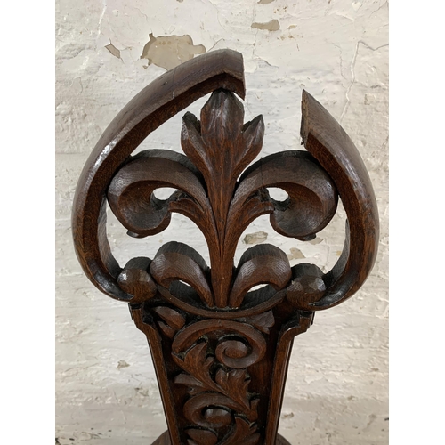 10 - A 19th century carved oak hall chair with acanthus leaf design - approx. 102cm high