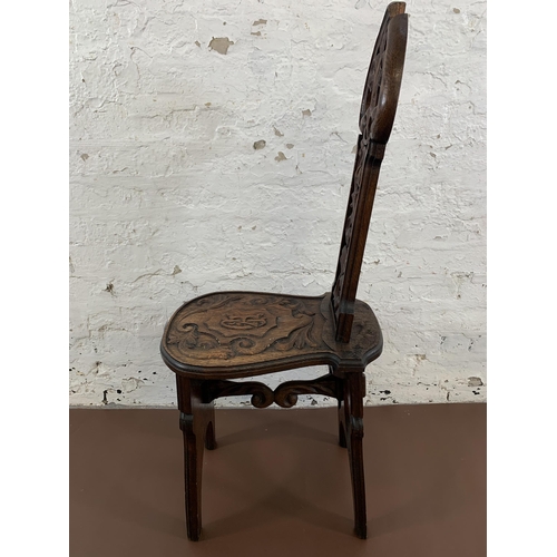 10 - A 19th century carved oak hall chair with acanthus leaf design - approx. 102cm high