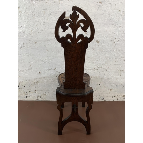 10 - A 19th century carved oak hall chair with acanthus leaf design - approx. 102cm high