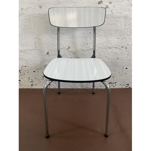 106 - Three mid 20th century white melamine and tubular metal stacking chairs