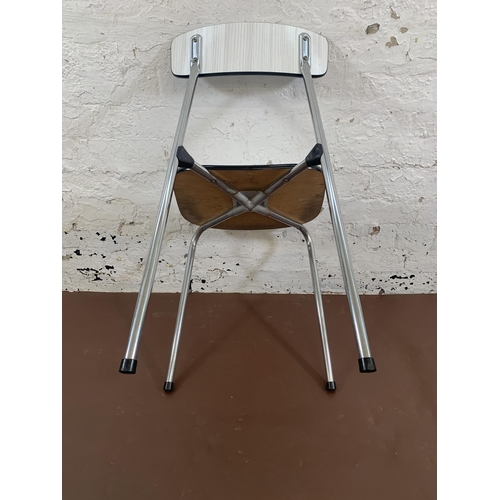 106 - Three mid 20th century white melamine and tubular metal stacking chairs