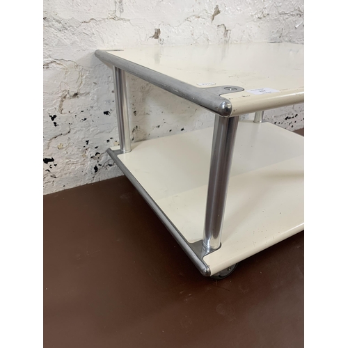 112 - A 1970s white metal and chrome plated two tier coffee table on castors - approx. 39cm high x 60cm wi... 