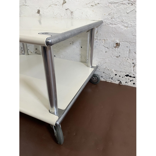 112 - A 1970s white metal and chrome plated two tier coffee table on castors - approx. 39cm high x 60cm wi... 