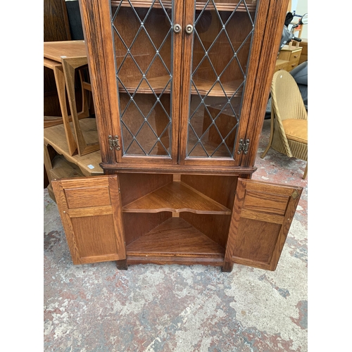 123 - An Old Charm carved oak free standing corner cabinet - approx. 167cm high