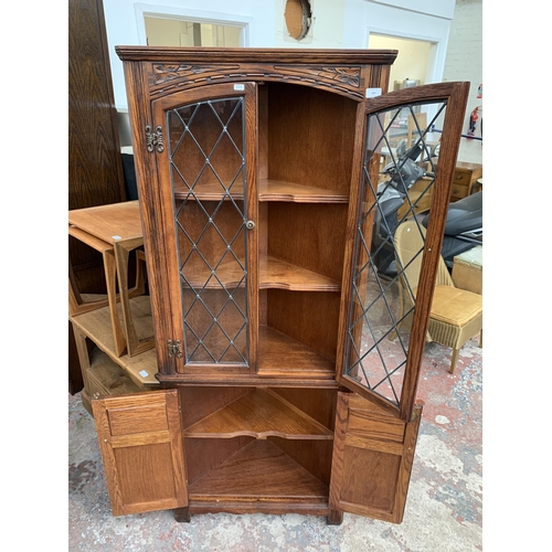 123 - An Old Charm carved oak free standing corner cabinet - approx. 167cm high