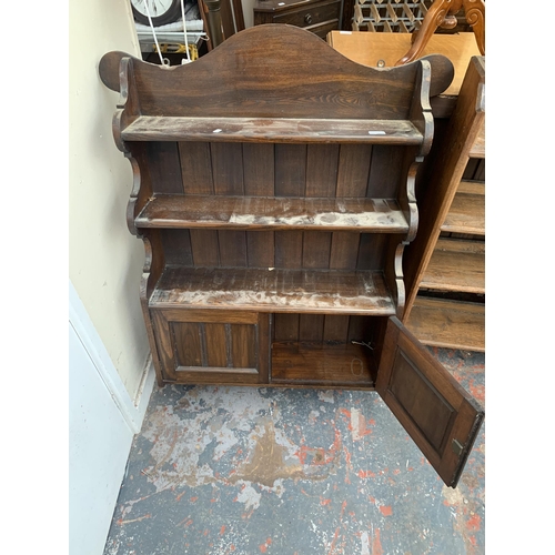 134 - An oak wall mountable three tier shelving unit with two lower cupboard doors - approx. 115cm high x ... 