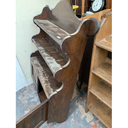 134 - An oak wall mountable three tier shelving unit with two lower cupboard doors - approx. 115cm high x ... 