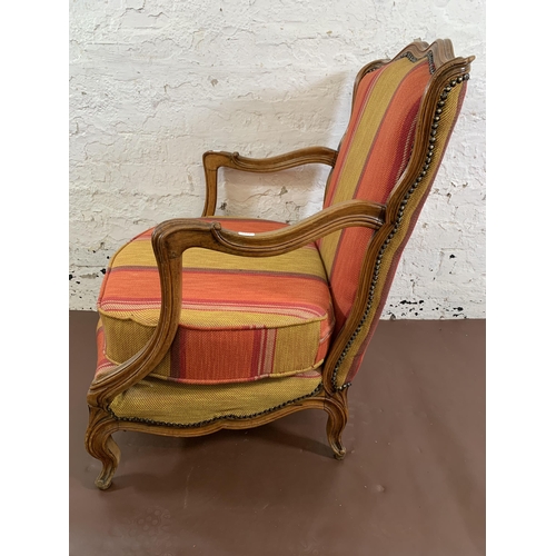 142 - A French style carved beech and fabric upholstered open armchair - approx. 86cm high x 68cm wide x 6... 