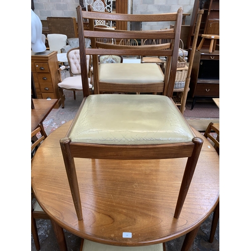 144 - A mid 20th century G Plan Fresco teak circular extending dining table and six chairs - table approx.... 