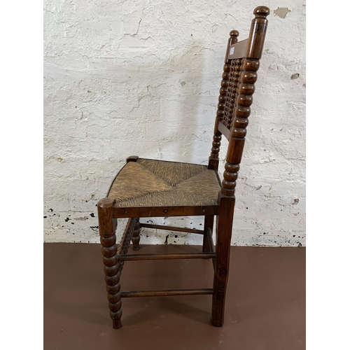 162 - A 19th century oak bobbin turned occasional chair with rush seat - approx. 94cm high x 46cm wide x 3... 