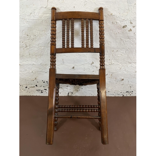 162 - A 19th century oak bobbin turned occasional chair with rush seat - approx. 94cm high x 46cm wide x 3... 