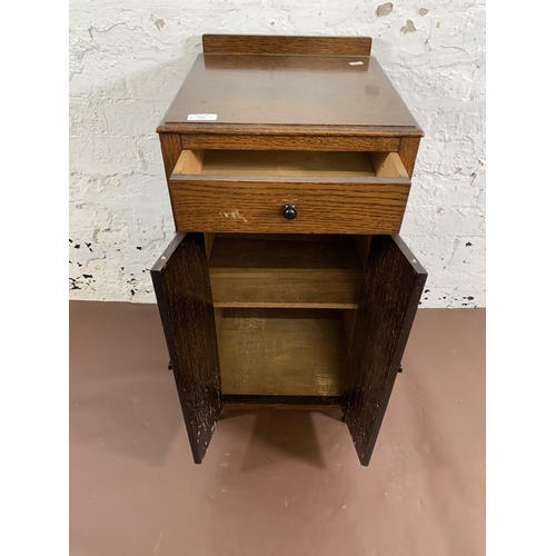 165 - A 1930s oak bedside cabinet - approx. 75cm high x 35cm wide x 38cm deep