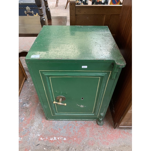 172 - A Victorian green painted cast iron safe with key (key in office) - approx. 62cm x 46cm wide x 45cm ... 