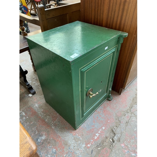 172 - A Victorian green painted cast iron safe with key (key in office) - approx. 62cm x 46cm wide x 45cm ... 