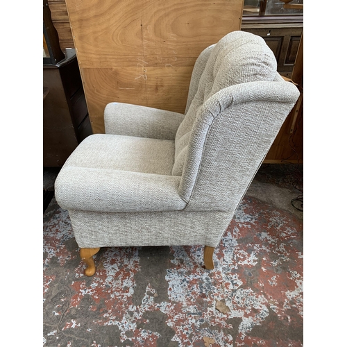 61 - A HSL fabric upholstered wingback armchair on beech cabriole supports