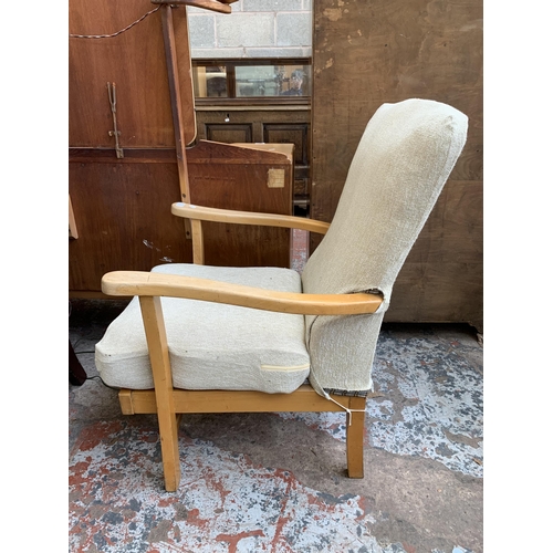 64 - A pair of mid 20th century beech and fabric upholstered armchairs