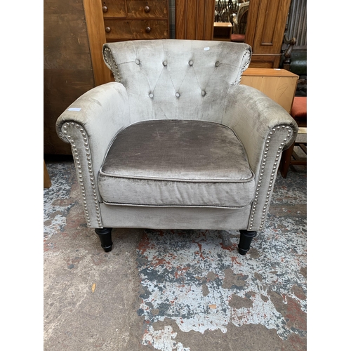 65 - A modern silver fabric upholstered armchair