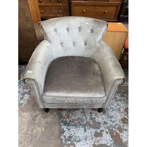 65 - A modern silver fabric upholstered armchair