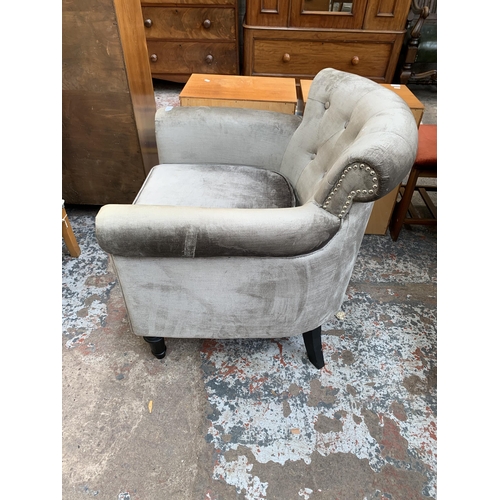 65 - A modern silver fabric upholstered armchair