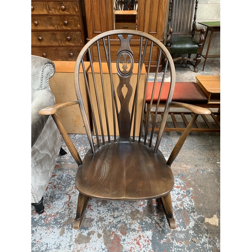 66 - An Ercol Fleur De Lys elm and beech rocking chair