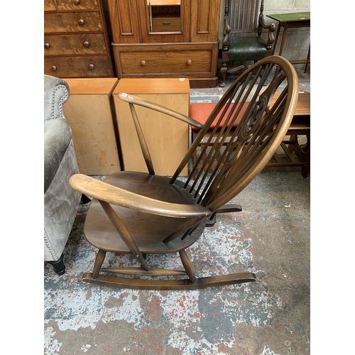 66 - An Ercol Fleur De Lys elm and beech rocking chair