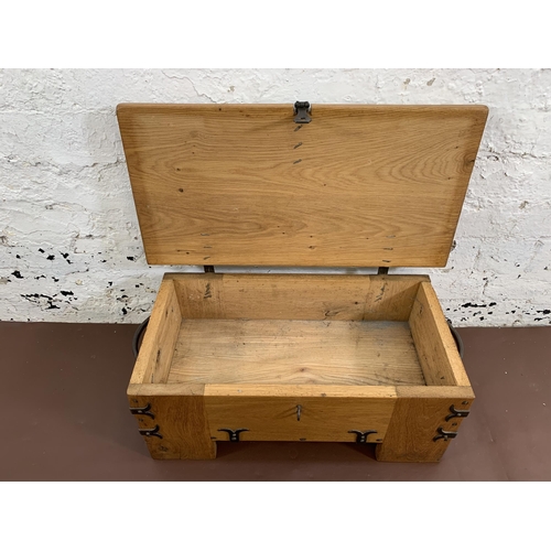 70 - A Medieval style oak and steel banded twin handled storage box - approx. 24cm high x 58cm wide x 30c... 