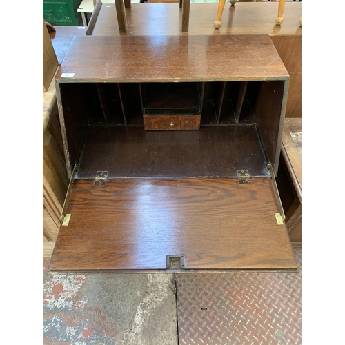 82 - A mid 20th century oak bureau with six fitted drawers - approx. 100cm high x 73cm high x 47cm deep