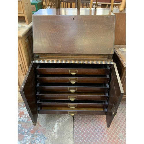 82 - A mid 20th century oak bureau with six fitted drawers - approx. 100cm high x 73cm high x 47cm deep